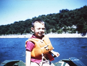 Me running motor in boat at age 8